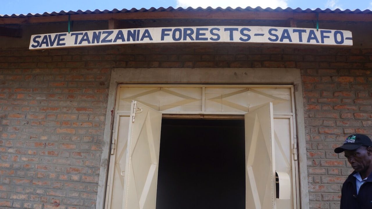Sign reading "Save Tanzania Forests - SATAFO - above building door.