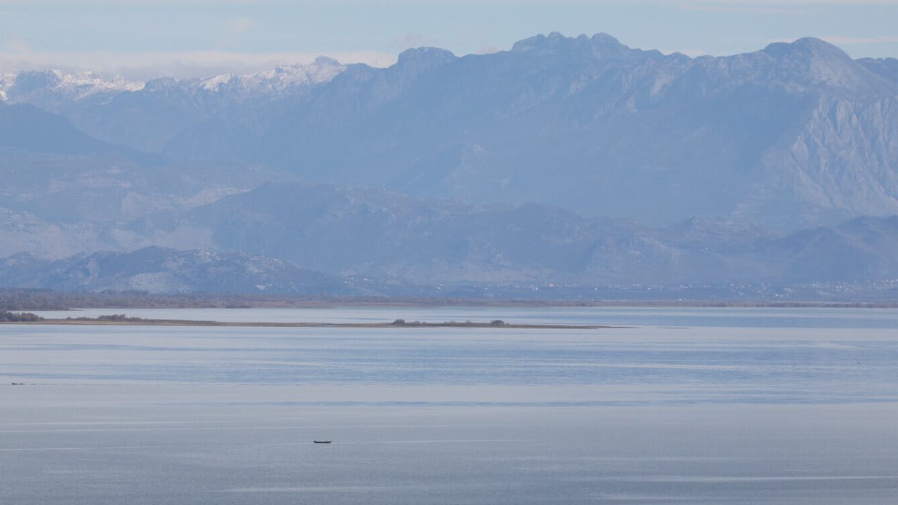 Lake, mountains in background.
