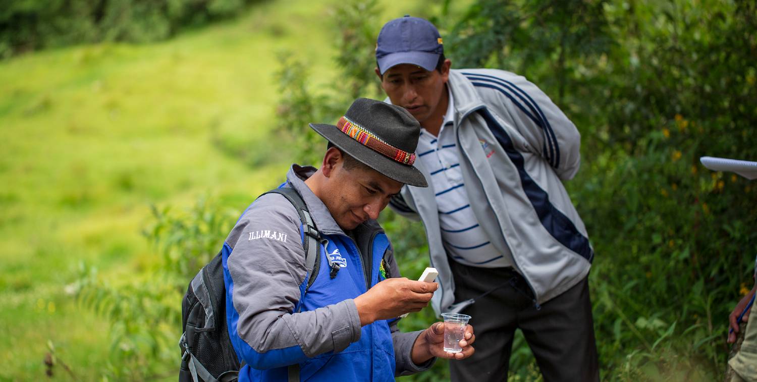 Two men examine water samples