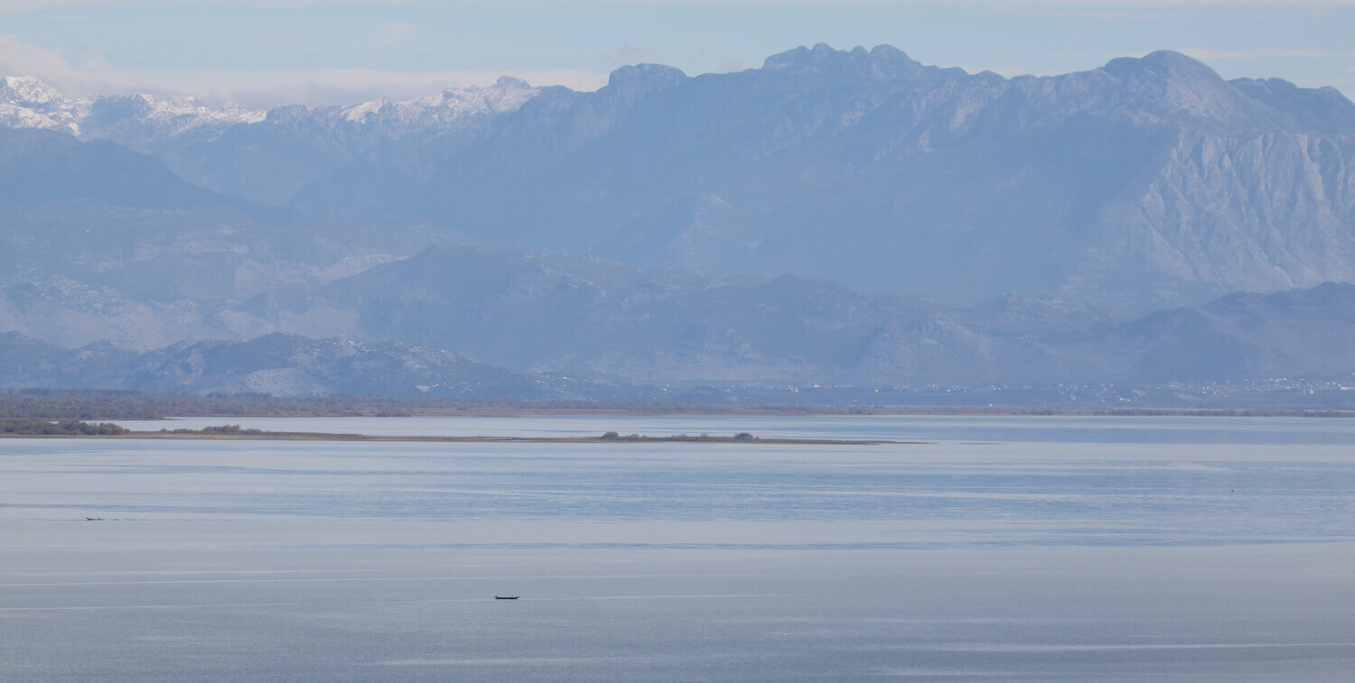 Lake, mountains in background.