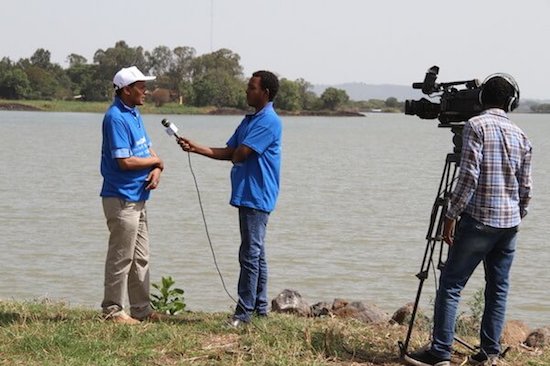 Man being interviewed by TV crew.