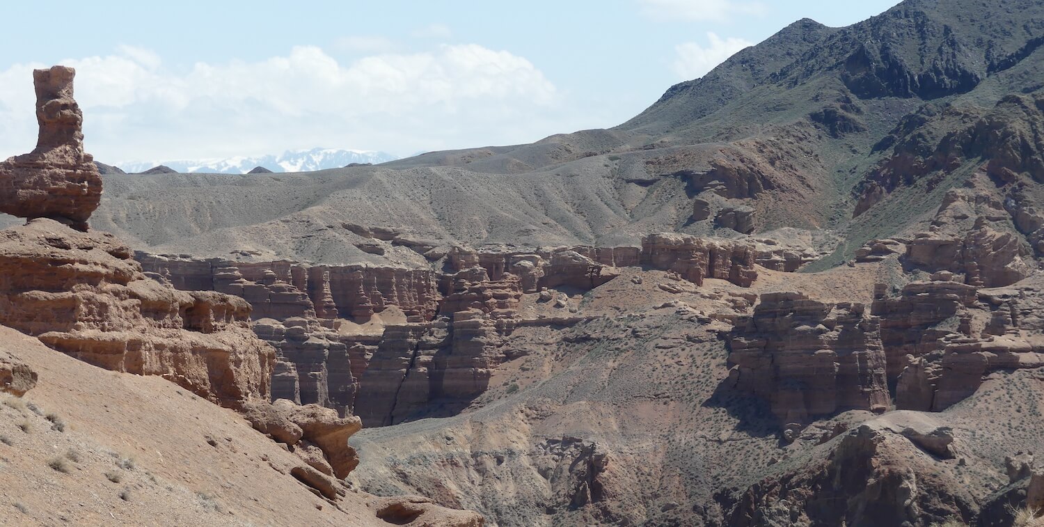 Landscape with brown, rocky formations.