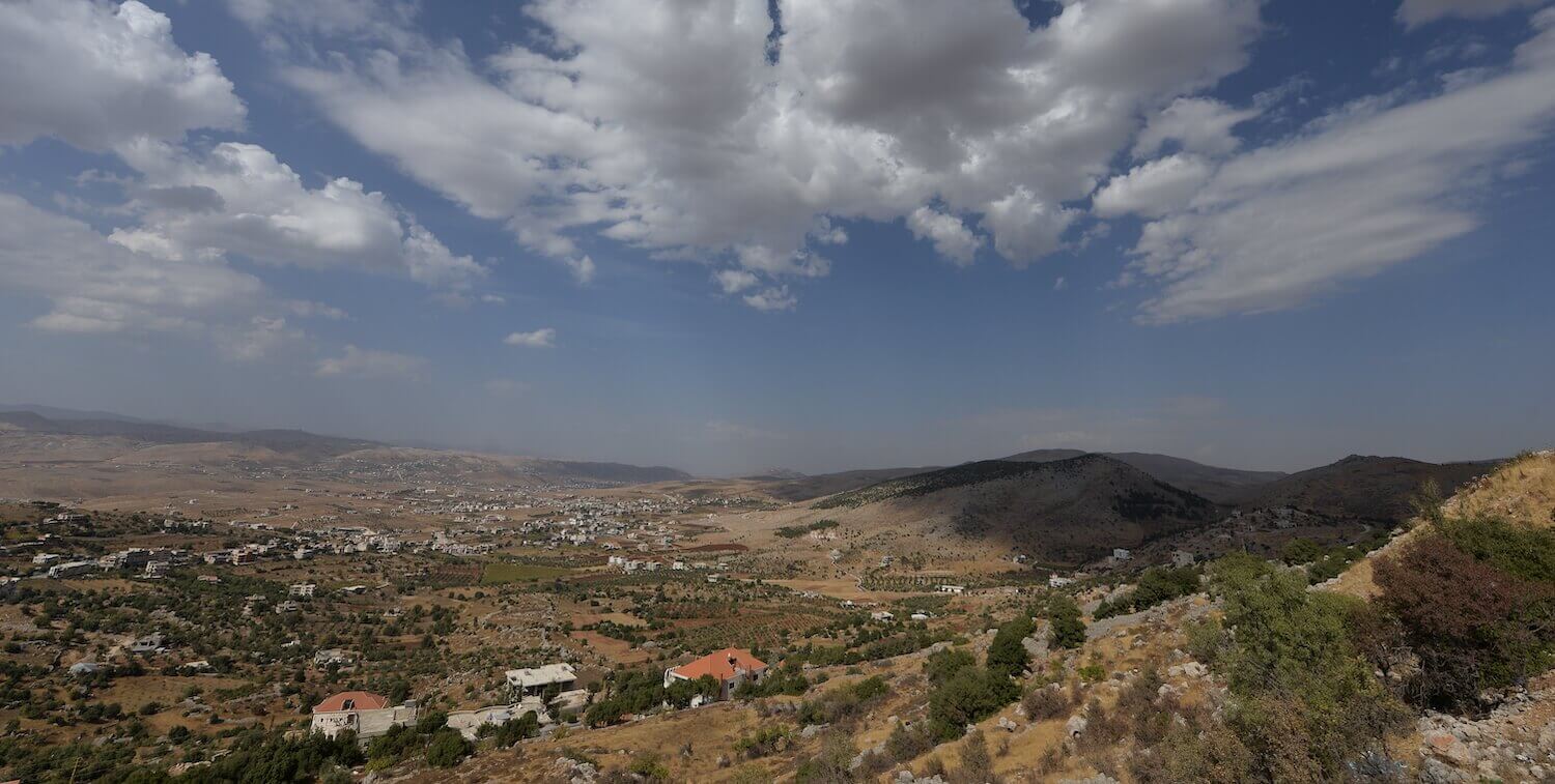 Hilly landscape, pockets of houses throughout.
