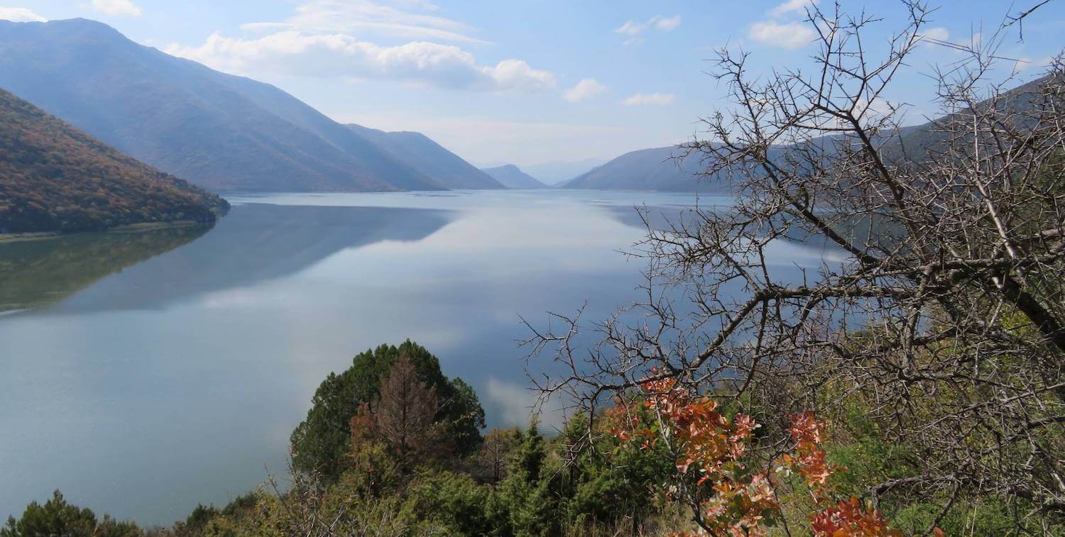 Scenic view of lake, mountains in background.
