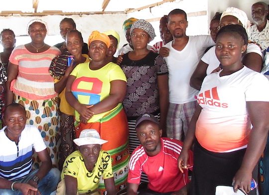 A small group of men and women pose for a photo.