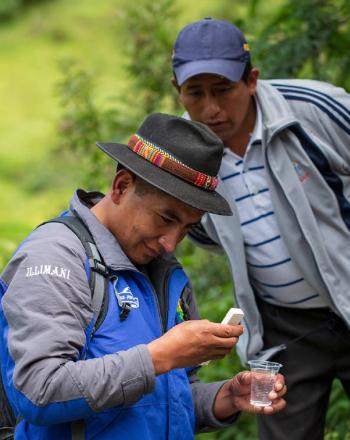 Two men examine water samples