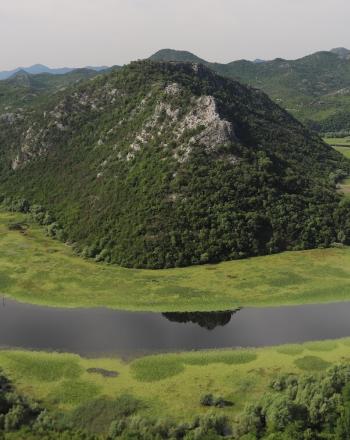 Lake circling around small mountain.
