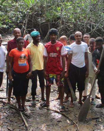 Group of young people standing in mangrove.