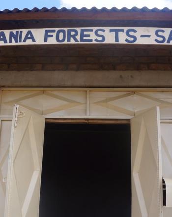 建物のドアの上に「タンザニアの森を救え-SATAFO-」と書かれた看板。