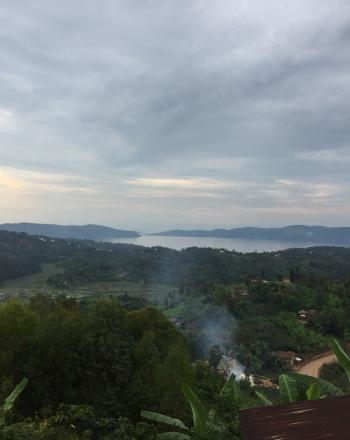 View of Lake Kivu in the distance over wooded hills