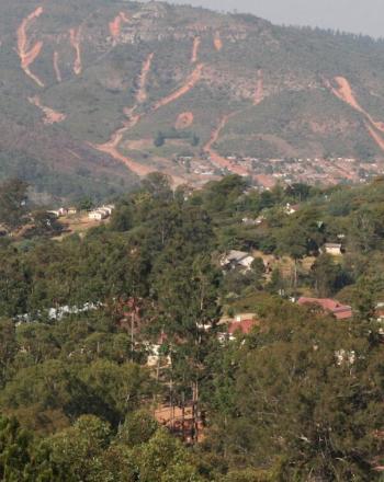 Hills in background, a few houses in foreground.