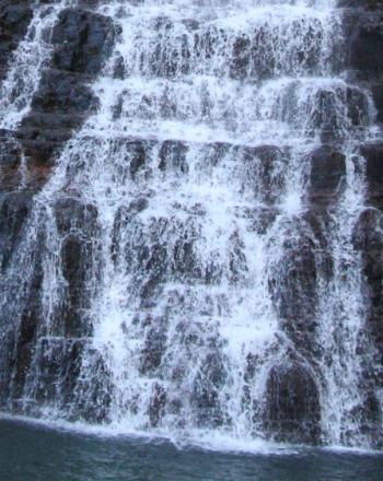 Bottom of a water fall down jagged rocks.